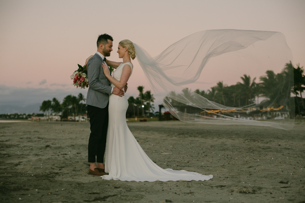 Bride & groom at Hilton Fiji Resort's beach